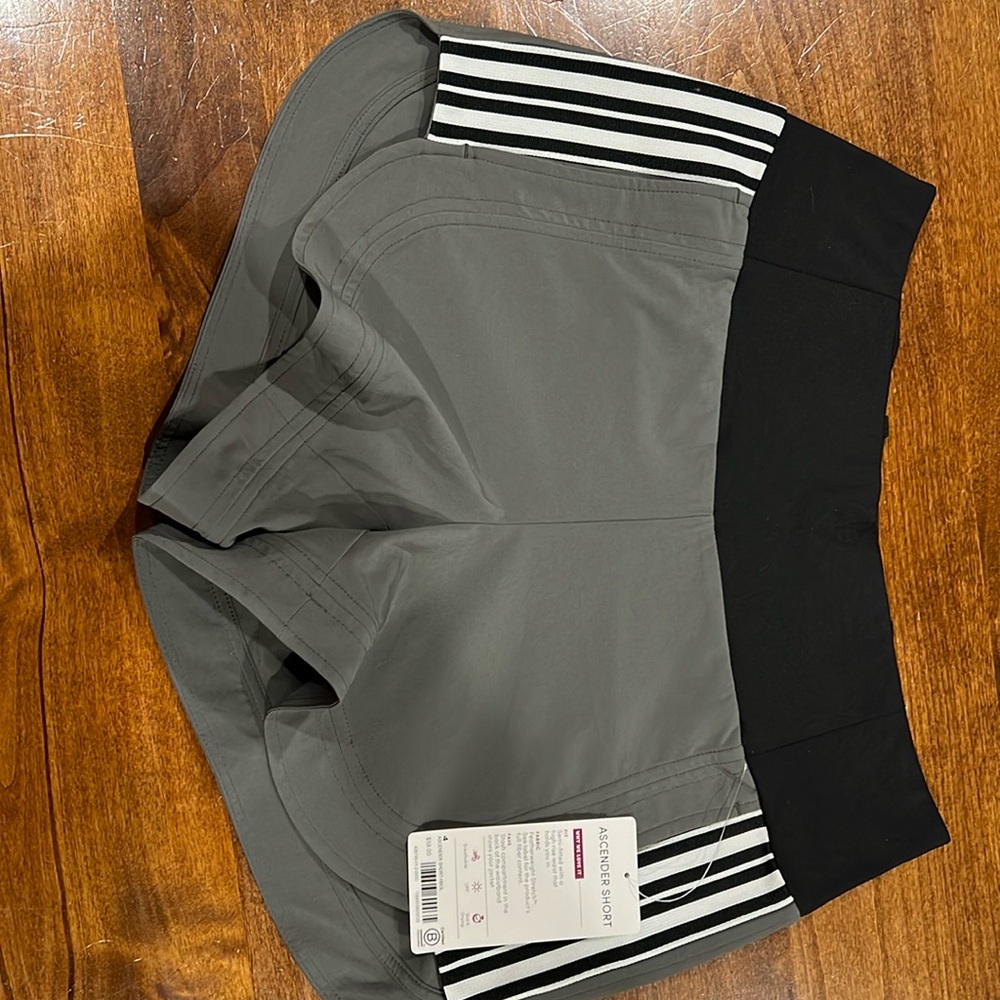 Athleta Ascender shorts in size 4. Dark grey/olive color. NWT